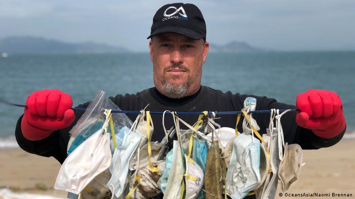 Gary Stokes from OceansAsia conservation group holds up surgical masks found on Soko Islands